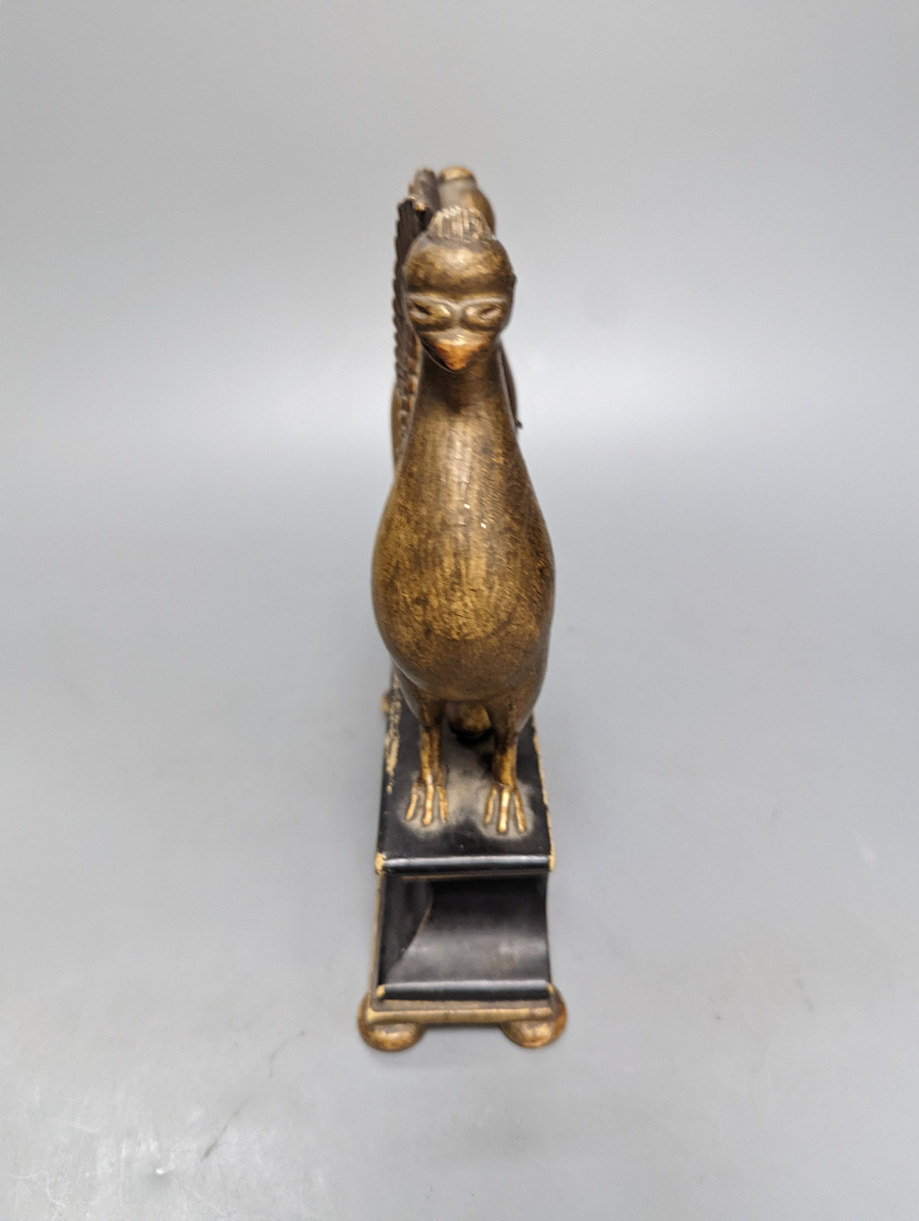 A carved and gilt watch stand, 22 cms high.